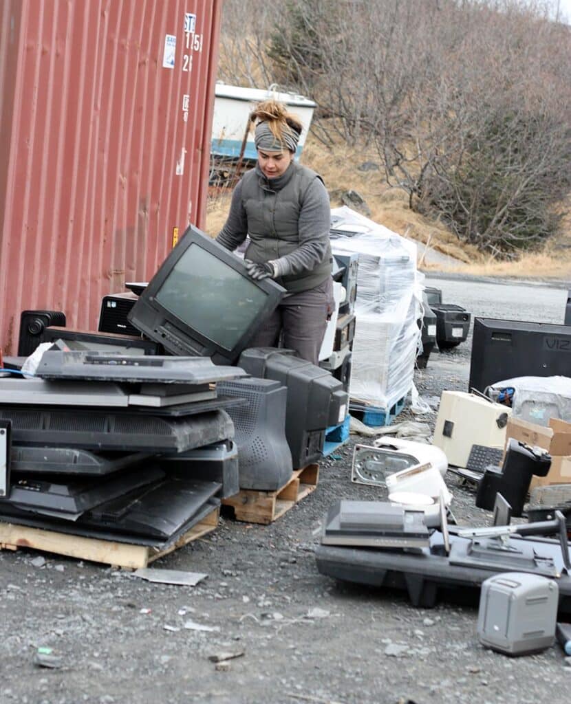 Woman going through old electronics
