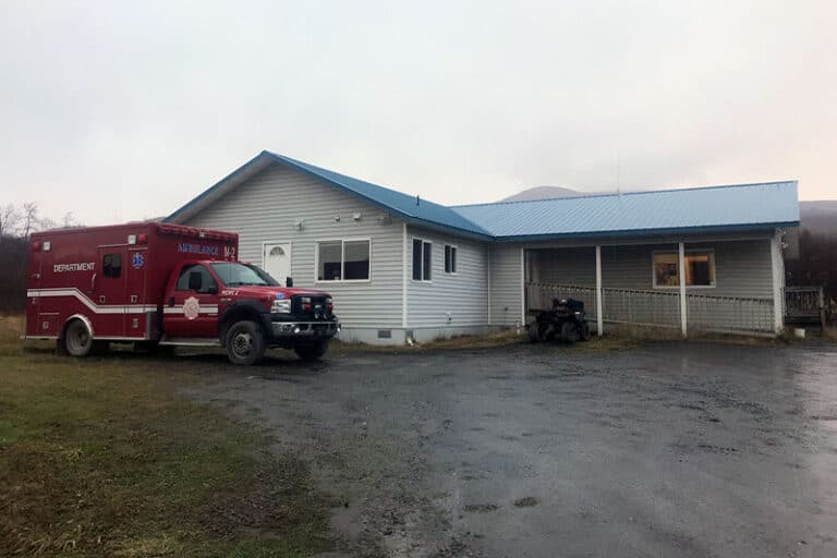 Larsen Bay building with an ambulance in front